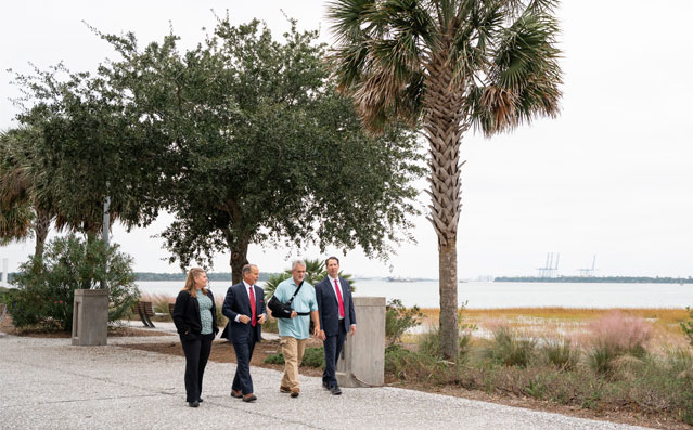 Peter David Brown team walking with personal injury client along Charleston waterfront